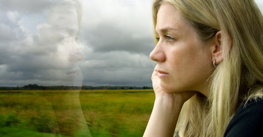 feeling loved - woman looking down in quiet reflection